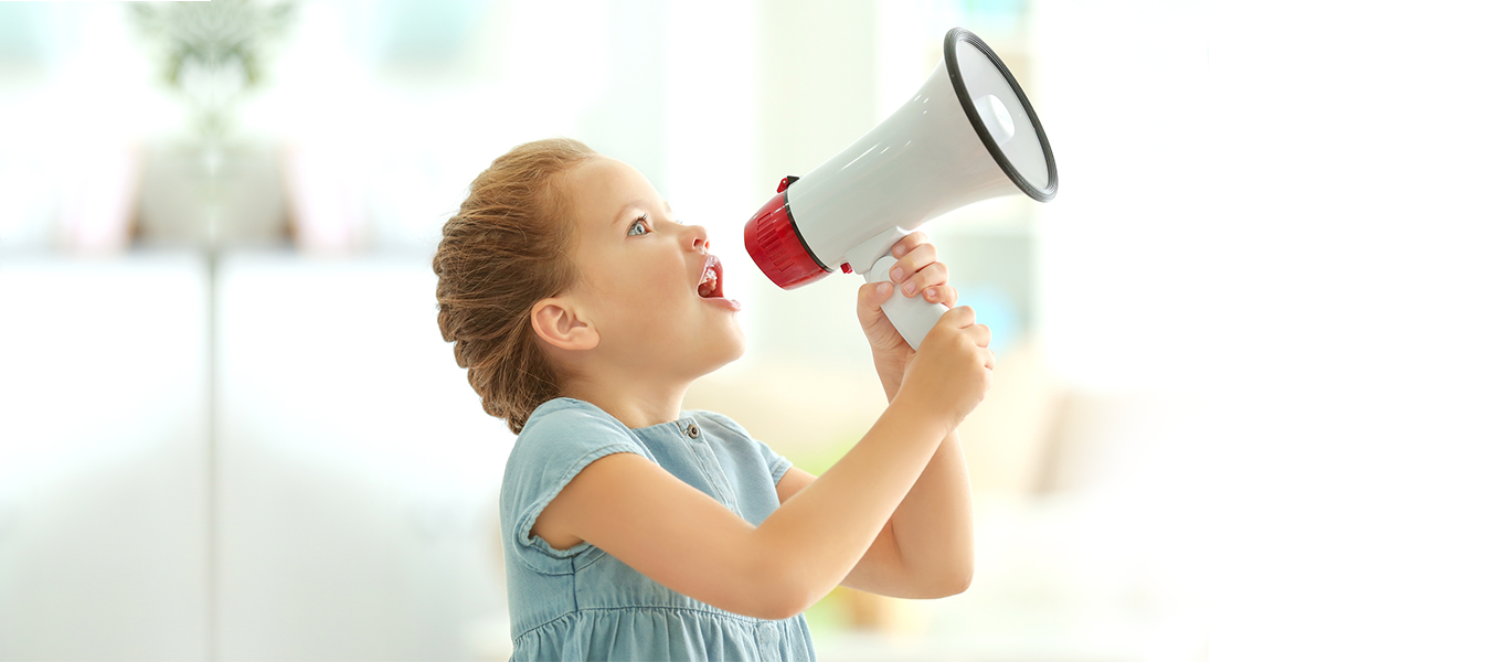 Cute little girl with megaphone at home image